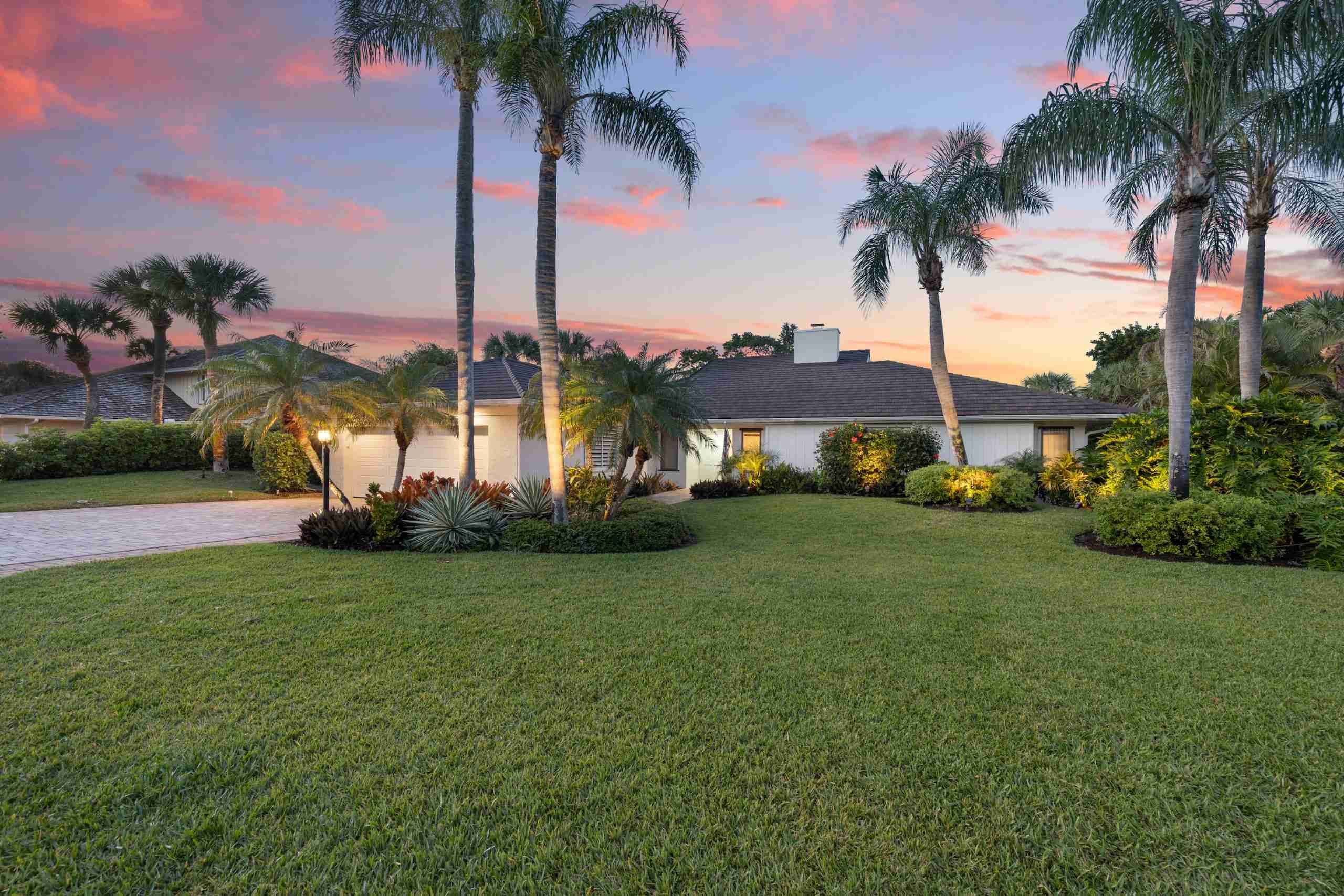 1810 Sand Dollar Way Vero Beach FL 32963 (6) Front of a home with palm trees and pink clouds